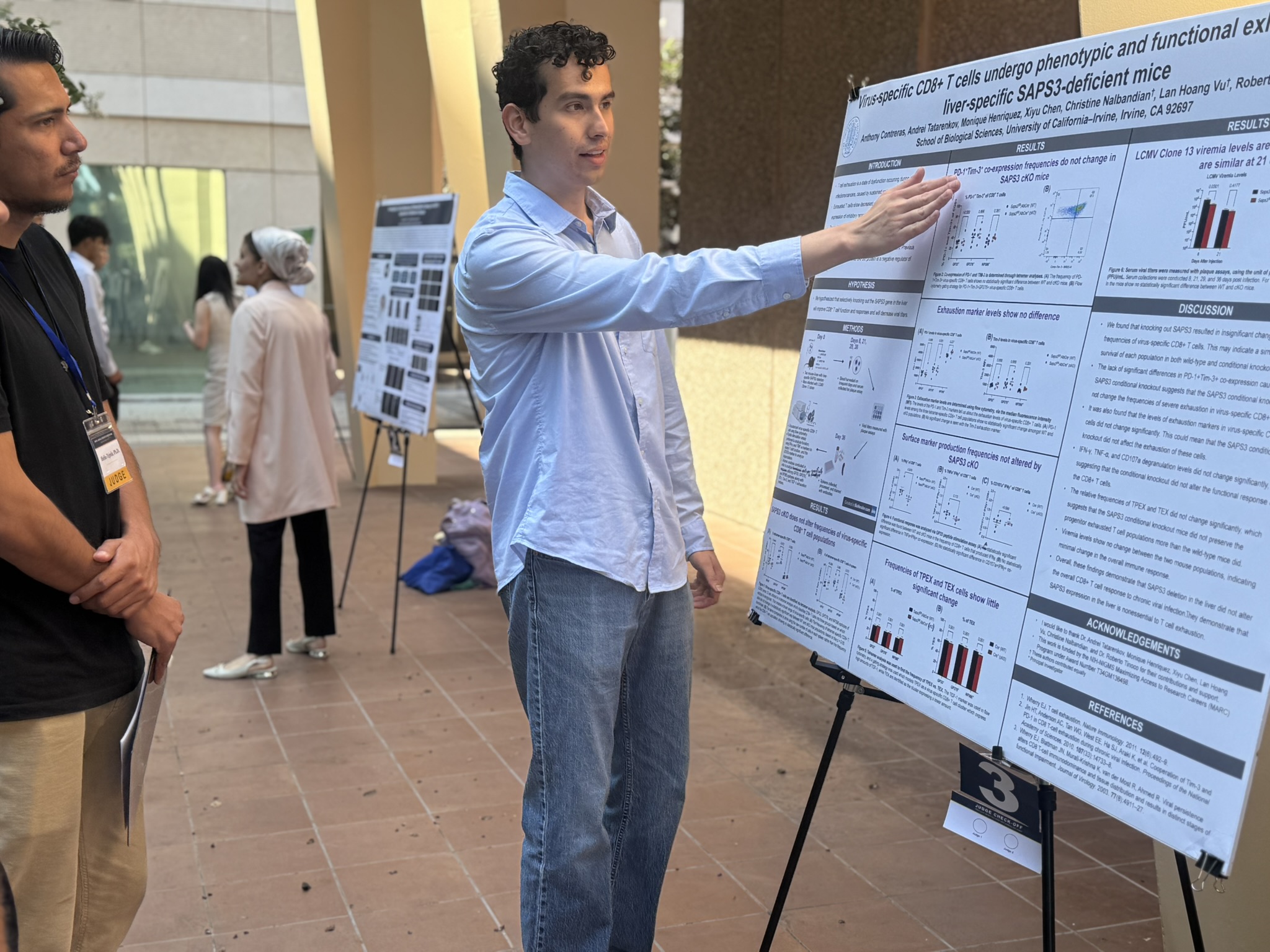 Scholar walking a visitor through his poster